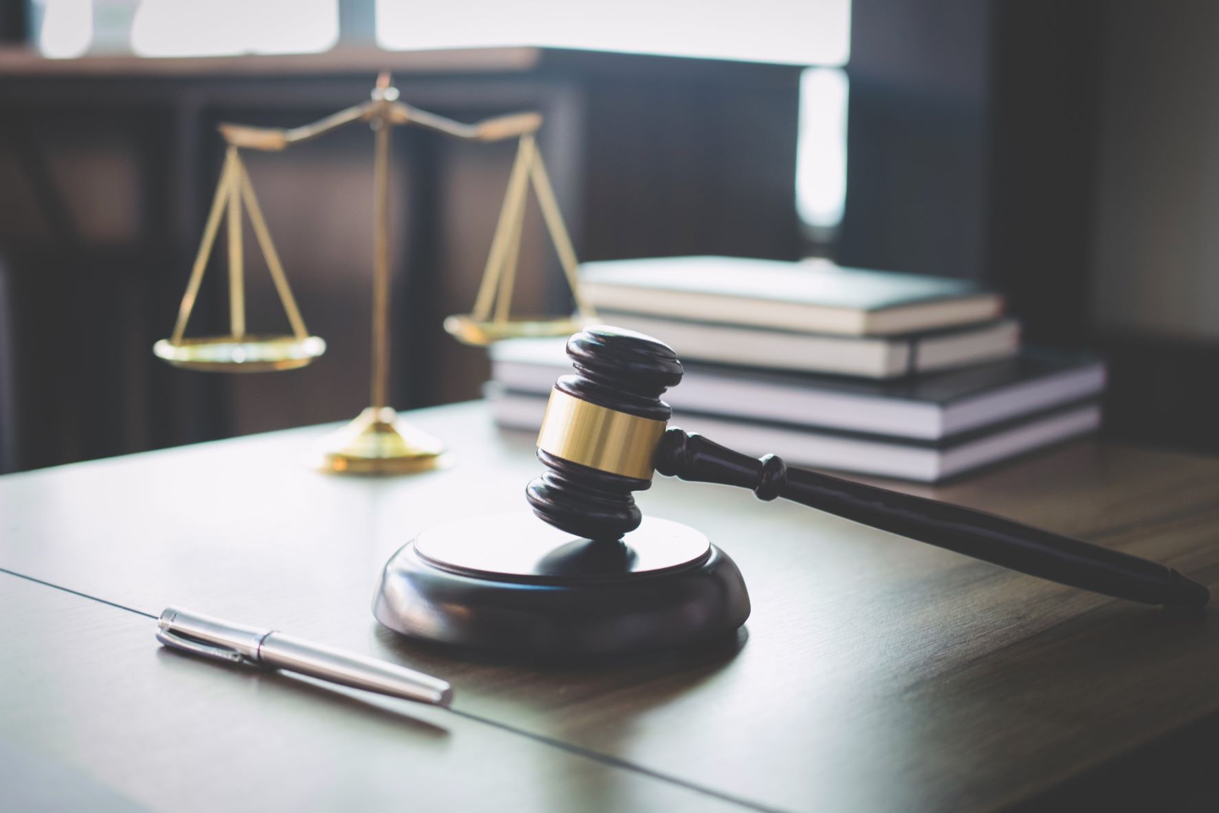 Scale of justice and Gavel on wooden table