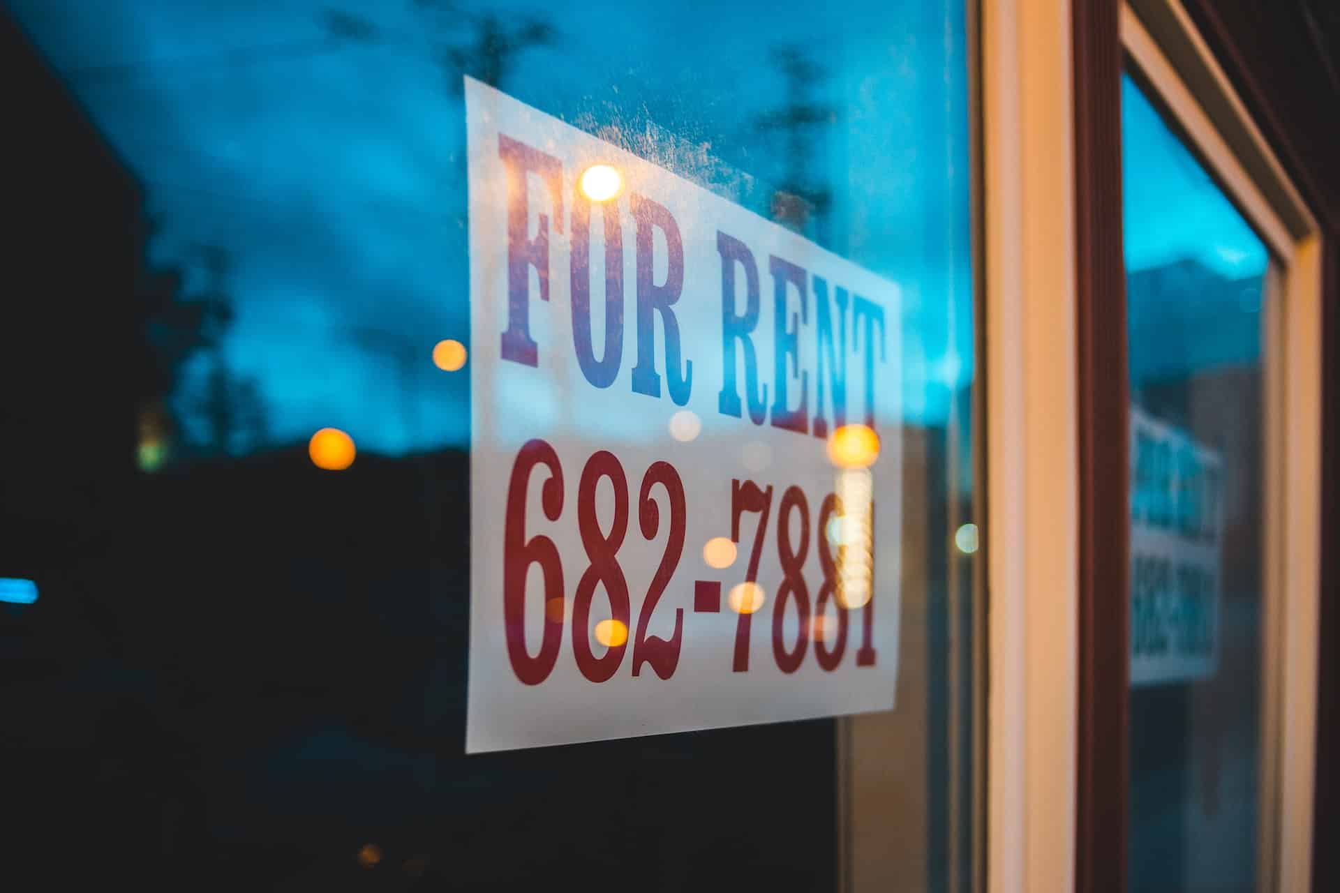 "For rent" sign on a window.